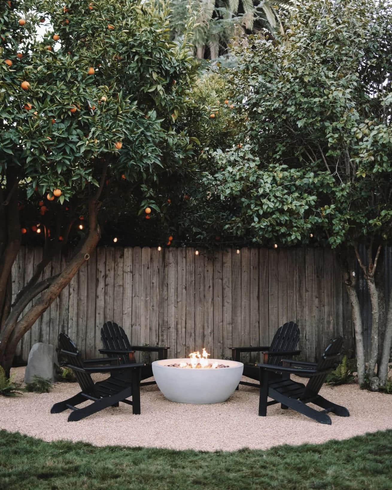 back patio with a fire pit and adirondack chairs