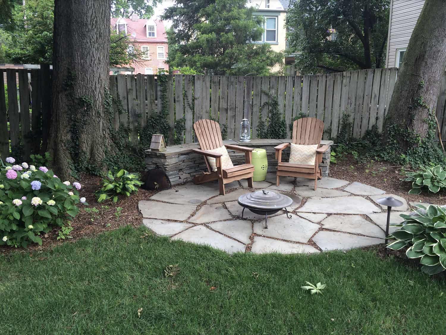 traditional patio with Adirondack chairs and a fire pit