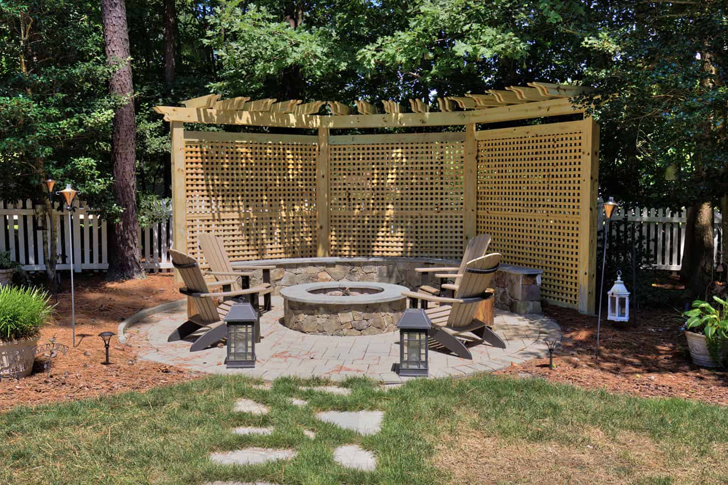 backyard stone patio with a pergola