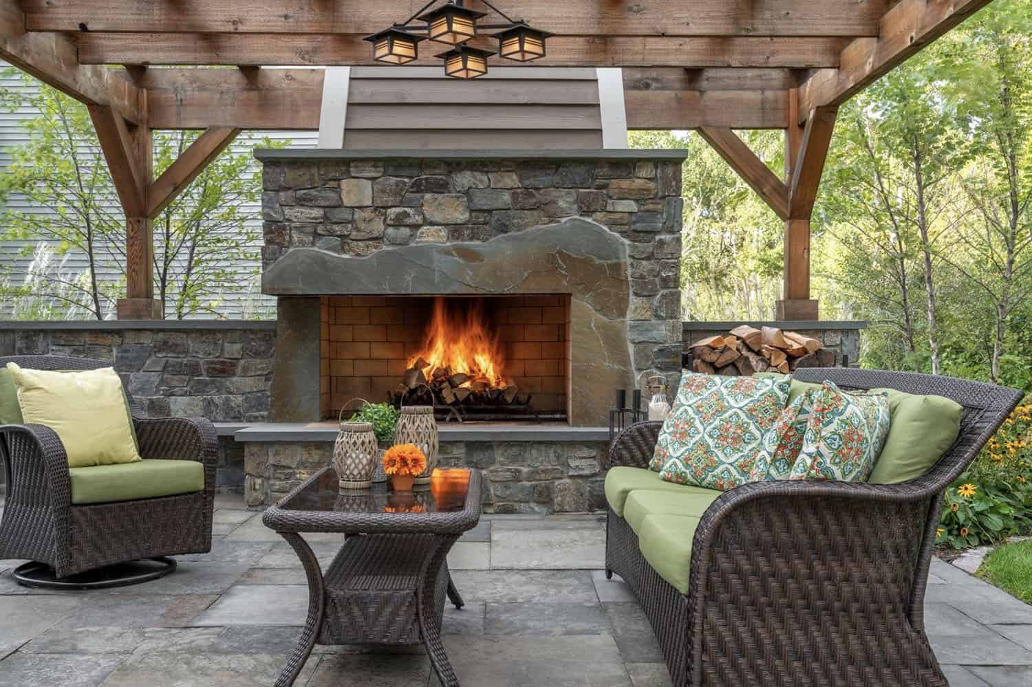 backyard patio with a statement stone fireplace