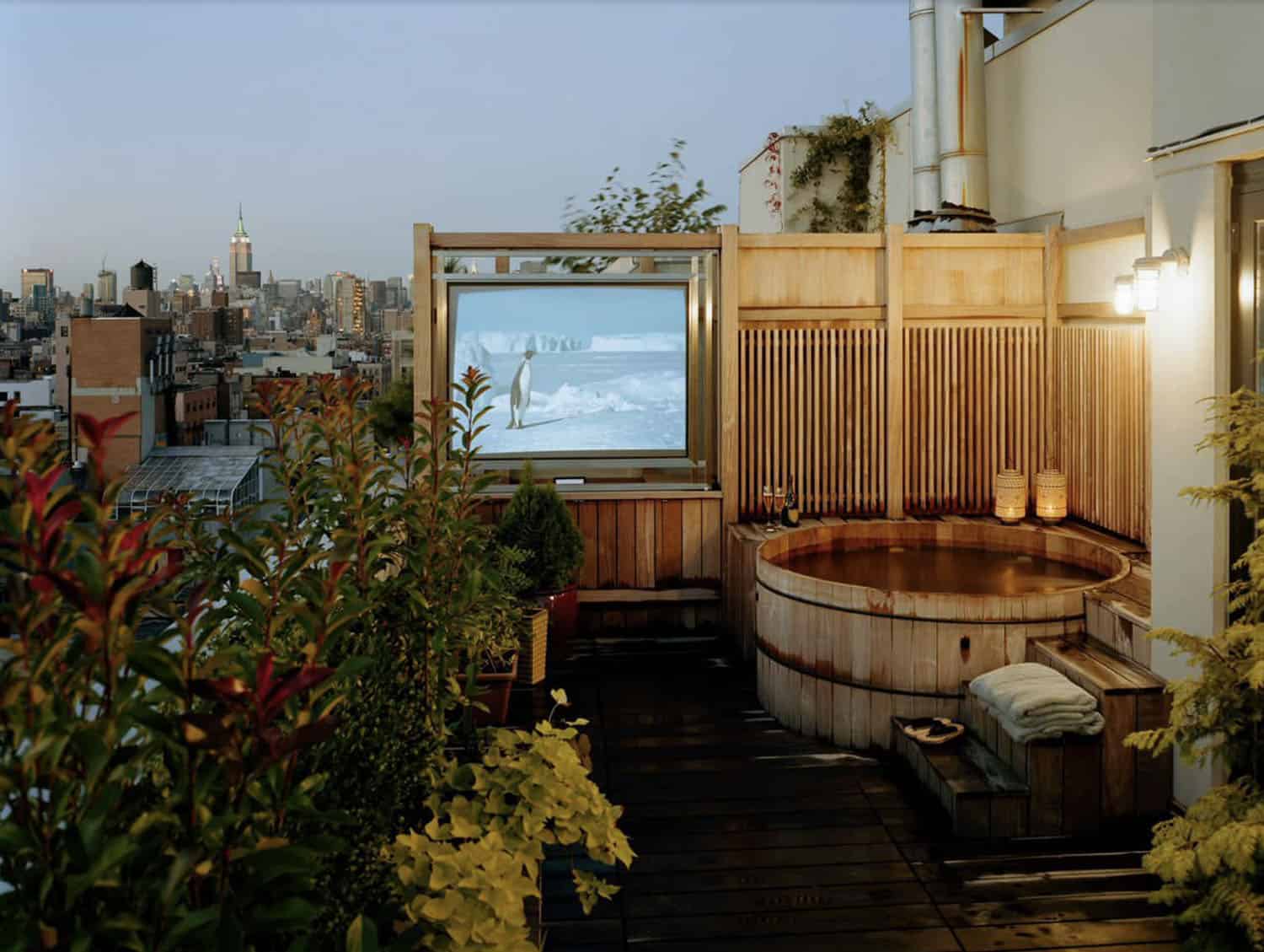 backyard hot tub with an outdoor TV