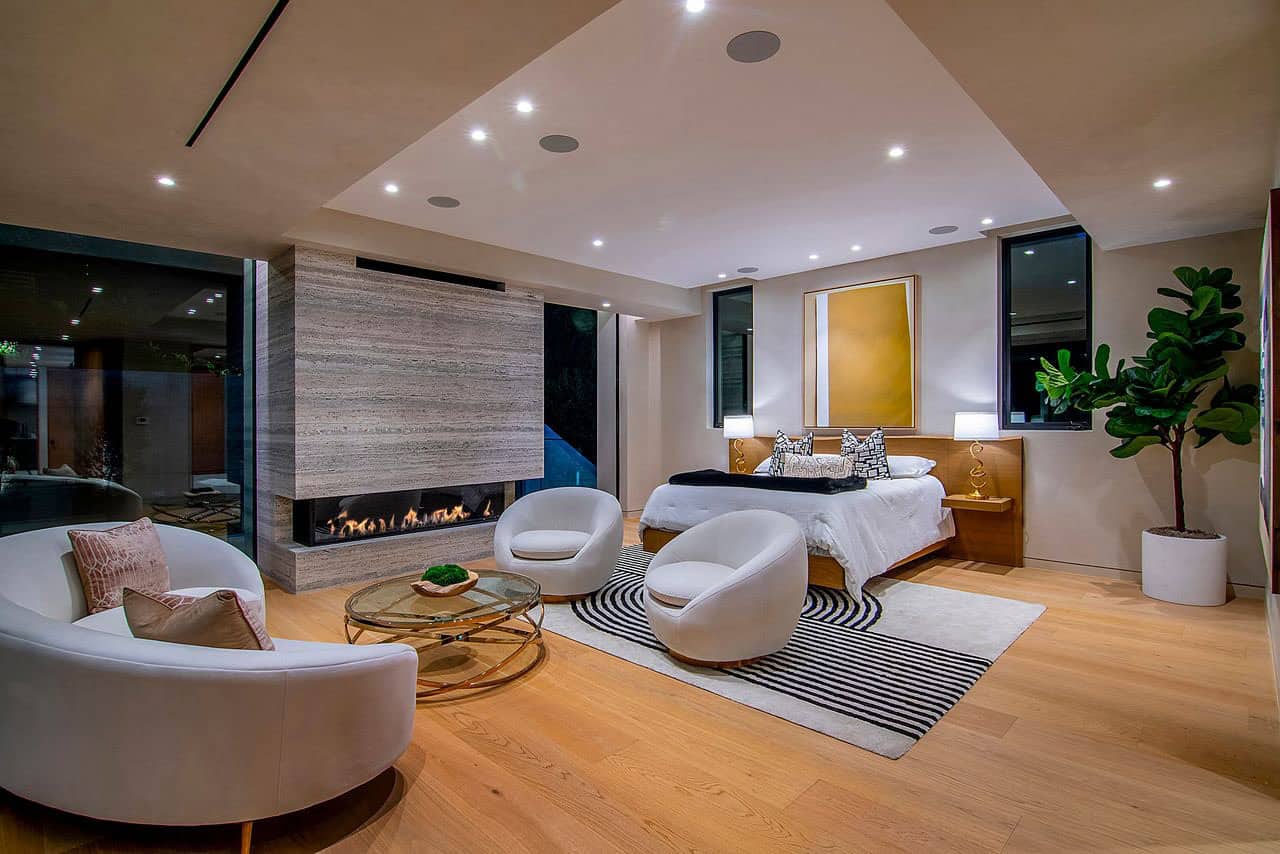 modern bedroom with a sitting area and fireplace