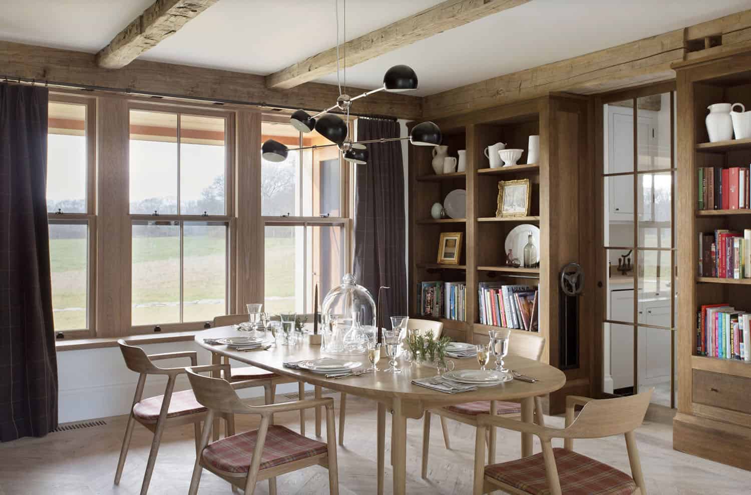 farmhouse style dining room with built-in bookshelves