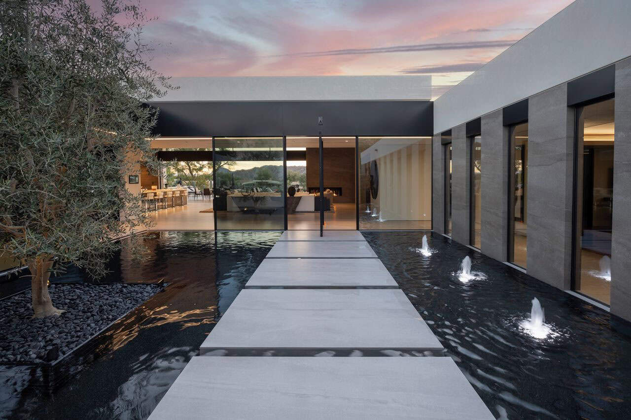 modern desert house exterior with a water feature