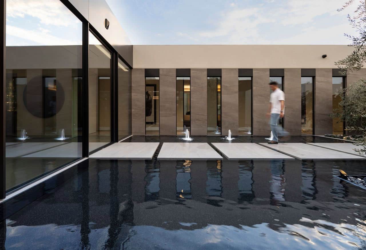 modern desert house exterior with a water feature
