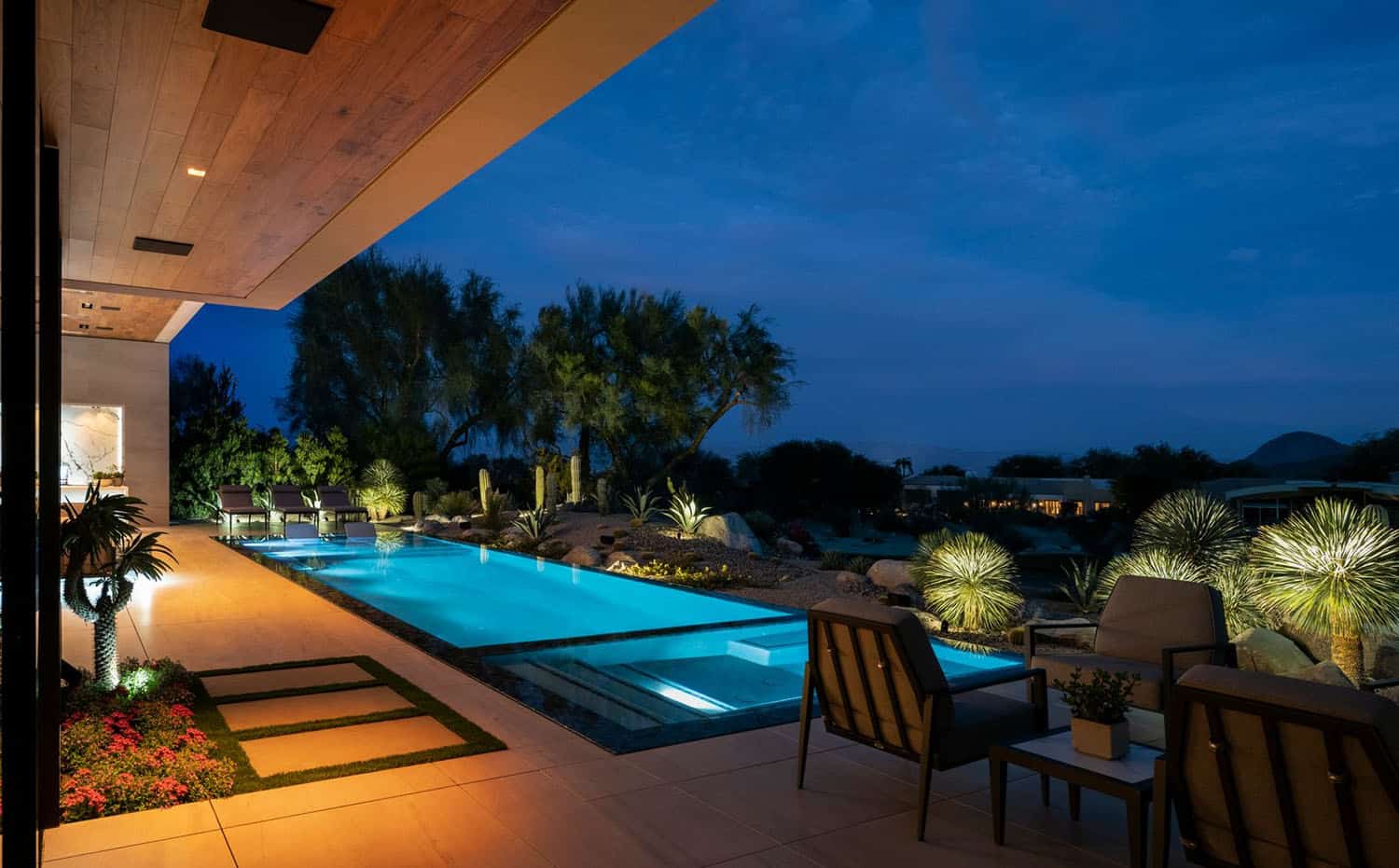 modern desert house exterior with a pool at dusk
