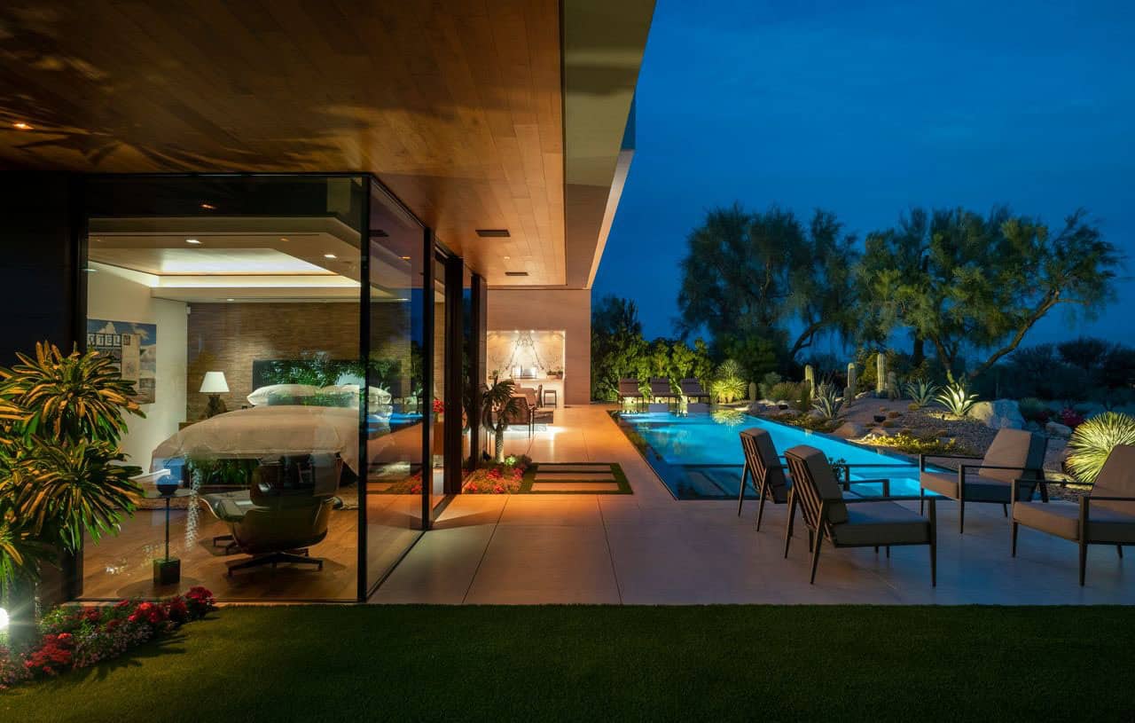 modern desert house exterior with a pool at dusk