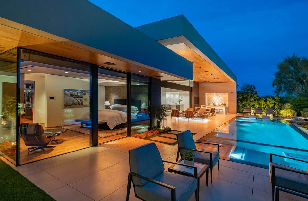 modern desert house exterior with a pool at dusk