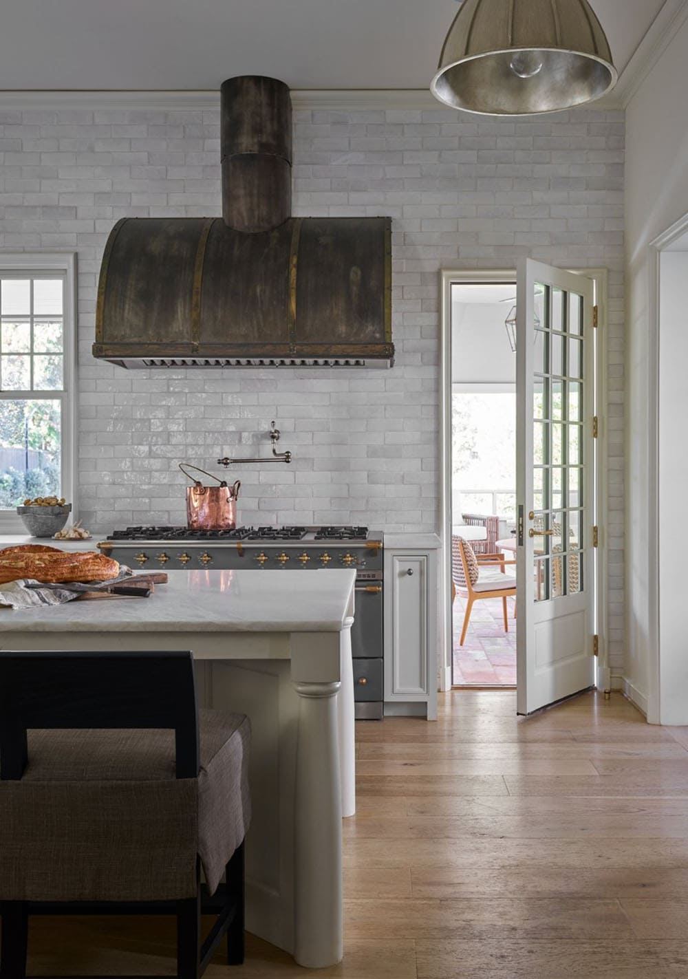 modern english tudor style kitchen with a custom metal hood