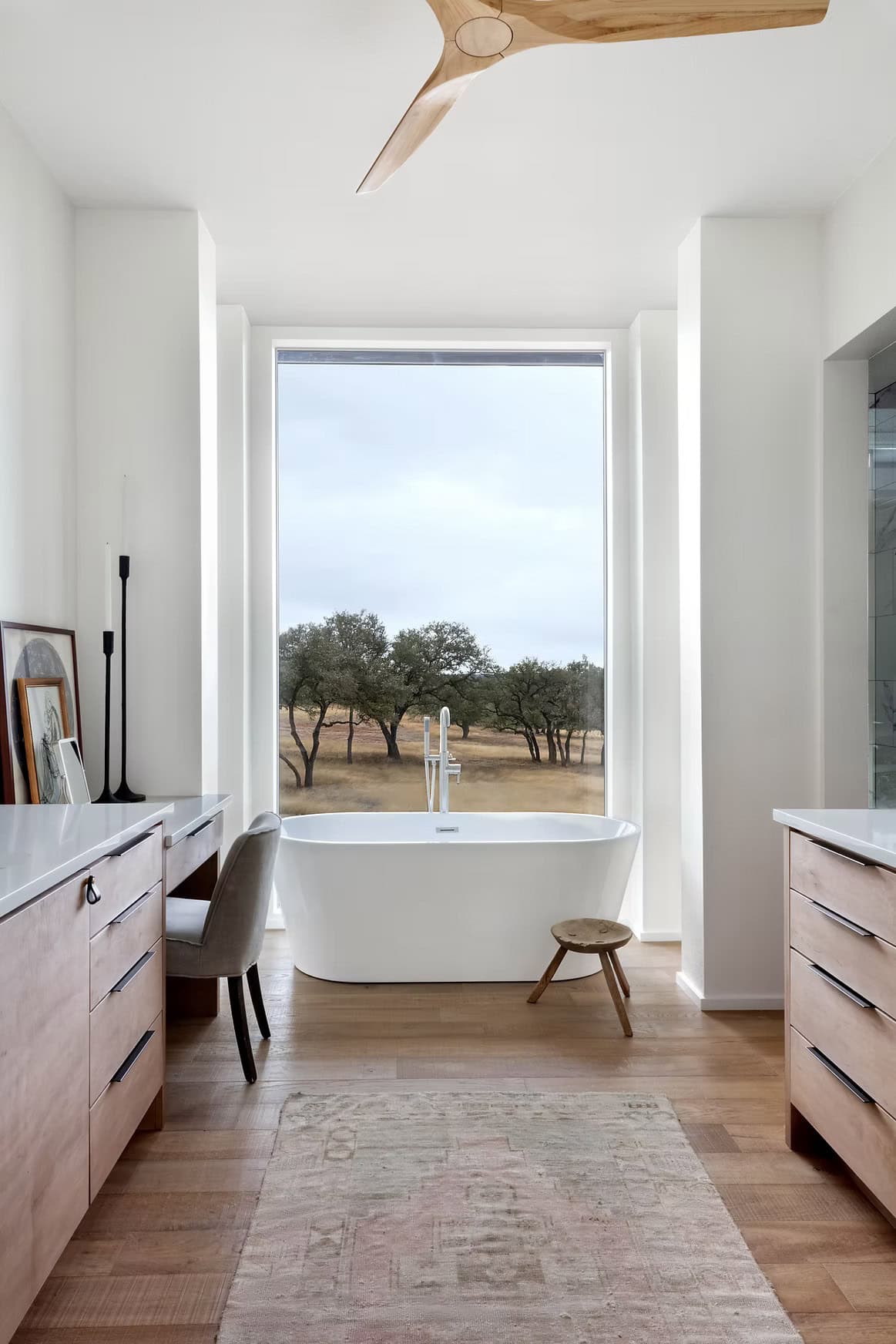 modern farmhouse style bathroom with dual vanities and a freestanding tub