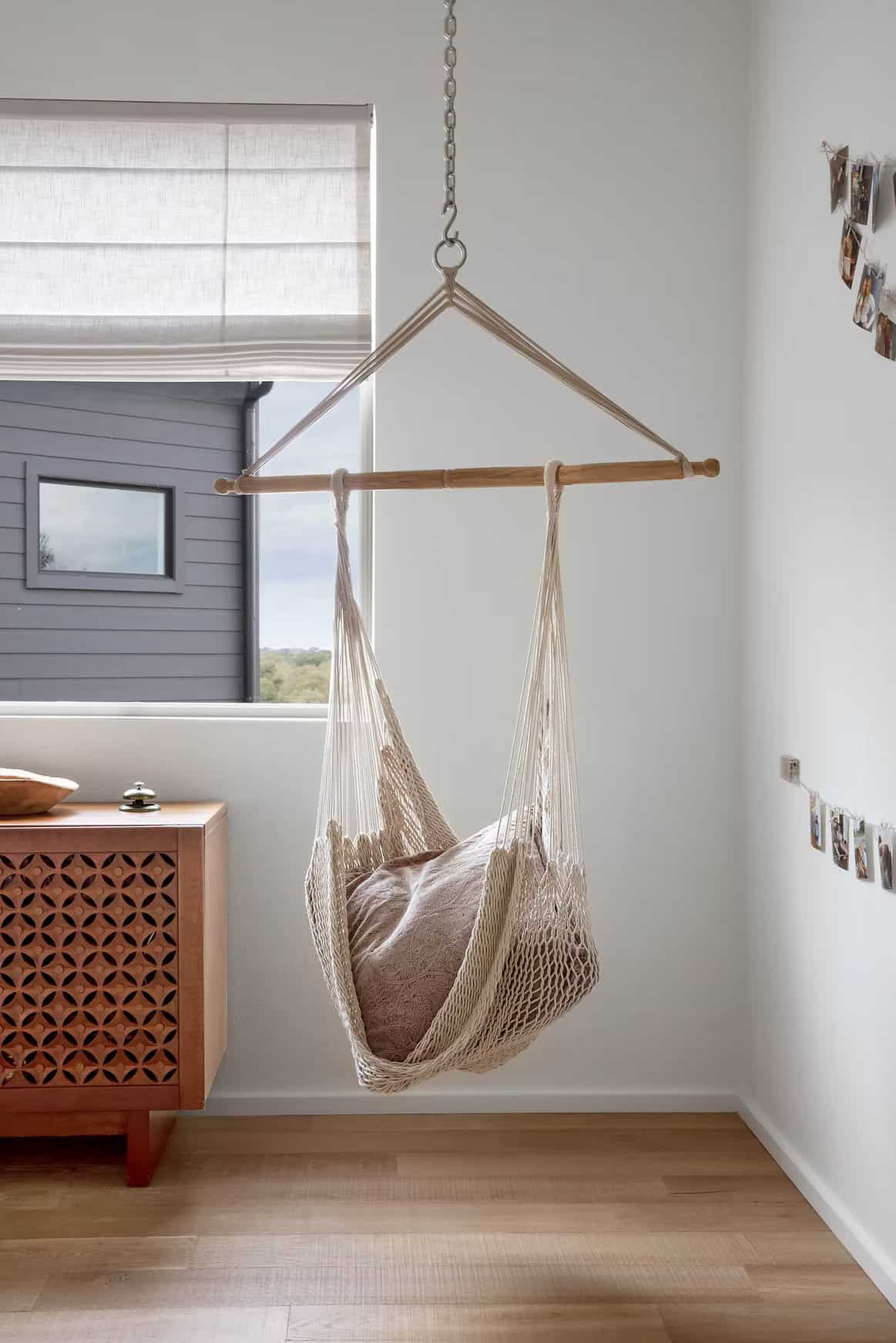 modern farmhouse style bedroom with a hanging chair