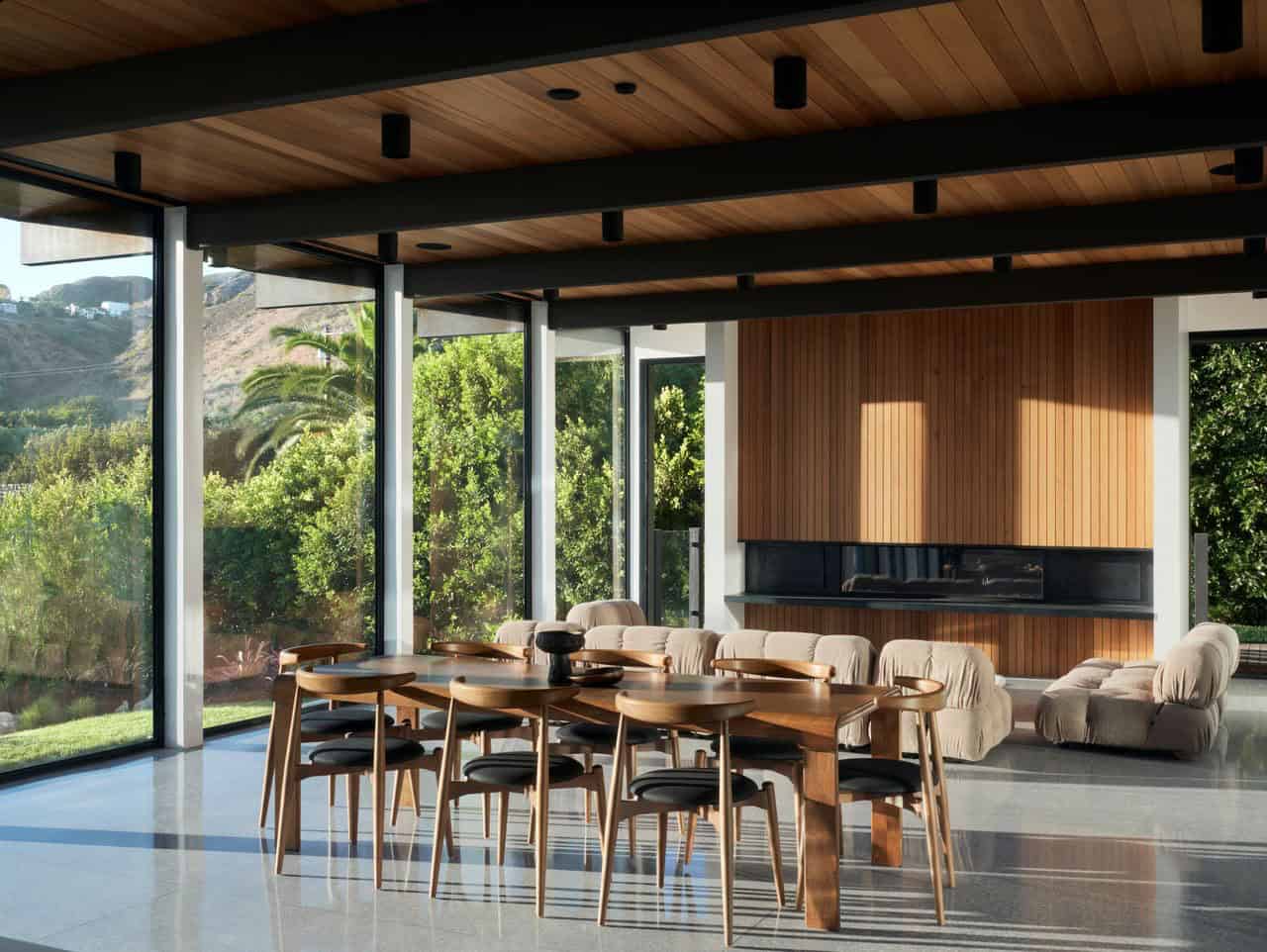 modern dining and living room with a fireplace