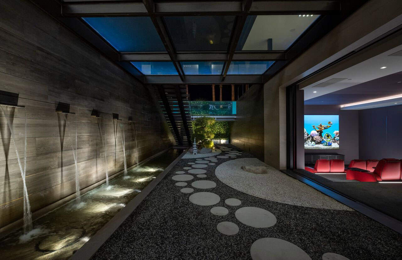 A modern home with a water feature and a movie screen.