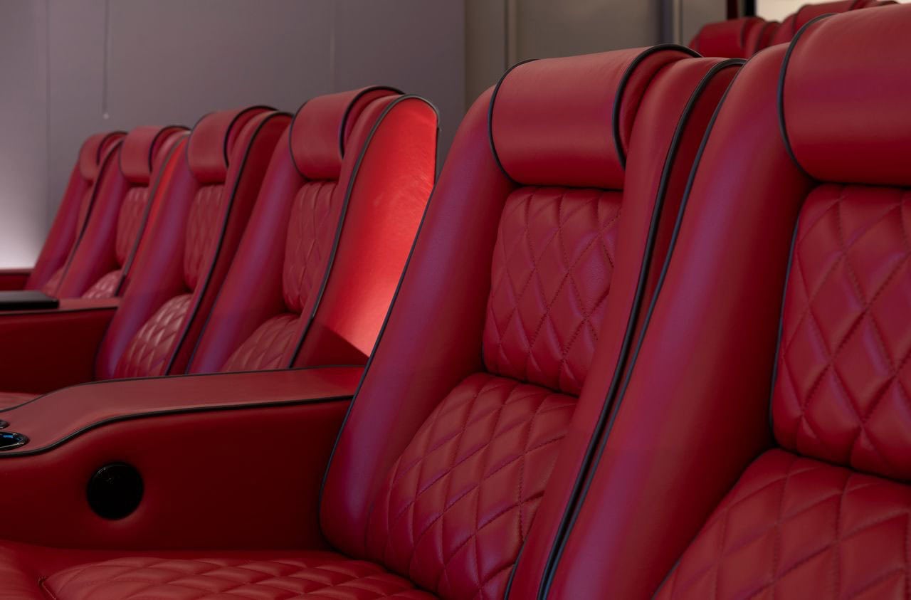 A red leather recliner in a home theater.