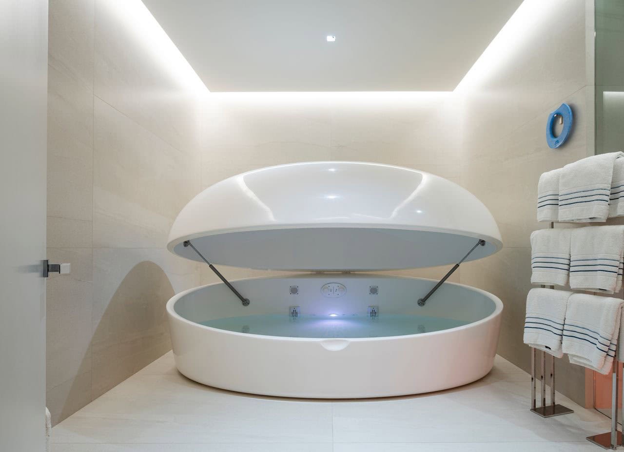A bathroom with red lighting and a sink.