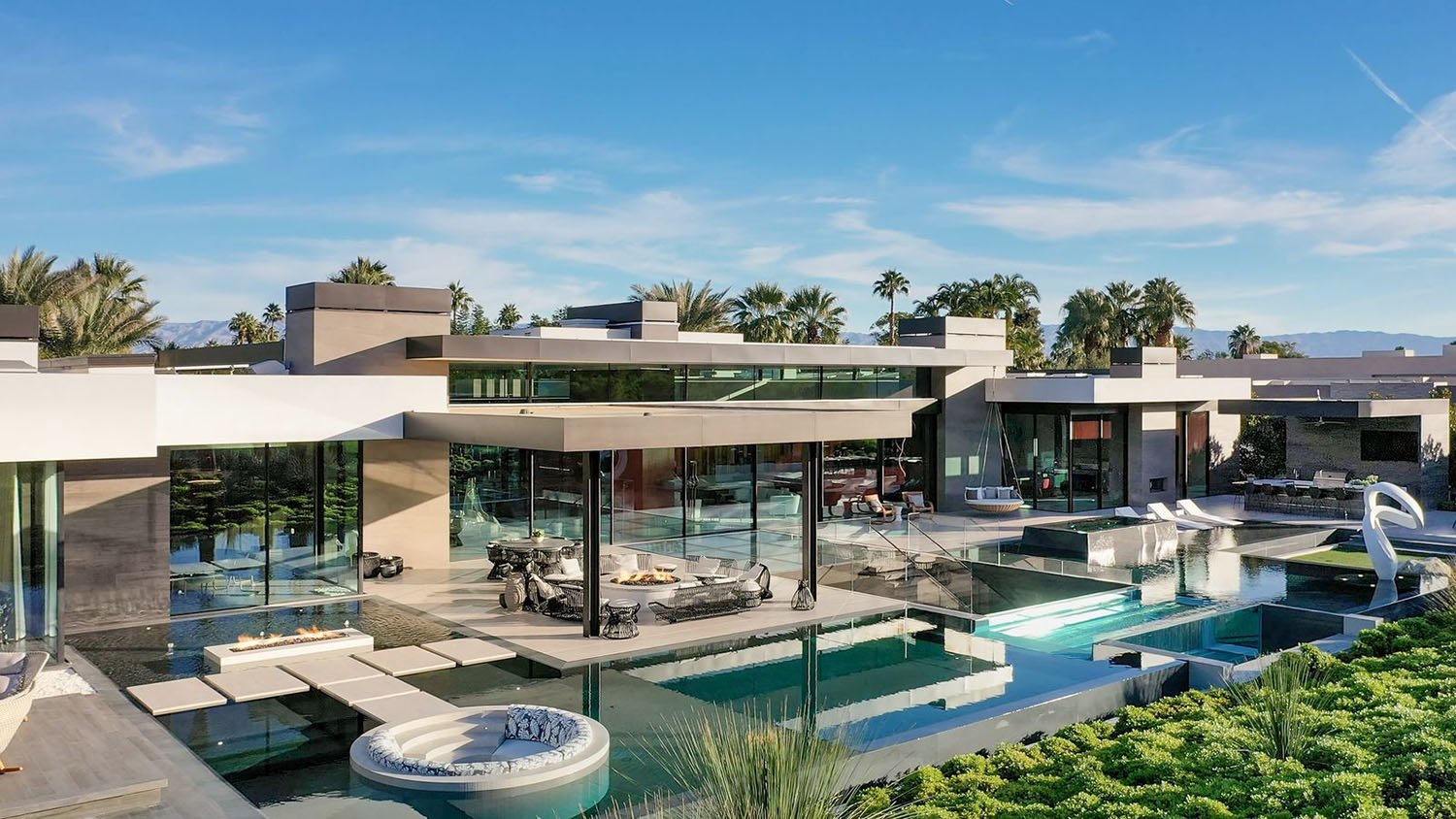 A modern home with a pool and patio.