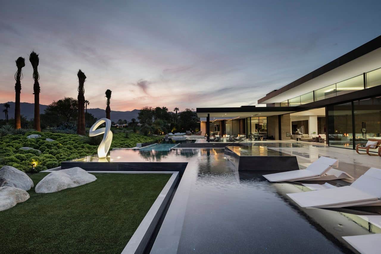 modern luxury house exterior with a pool at dusk