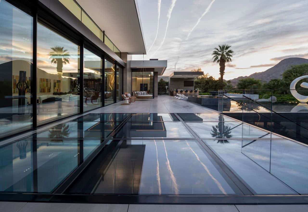 A pool with a circular fire pit in the middle of it.