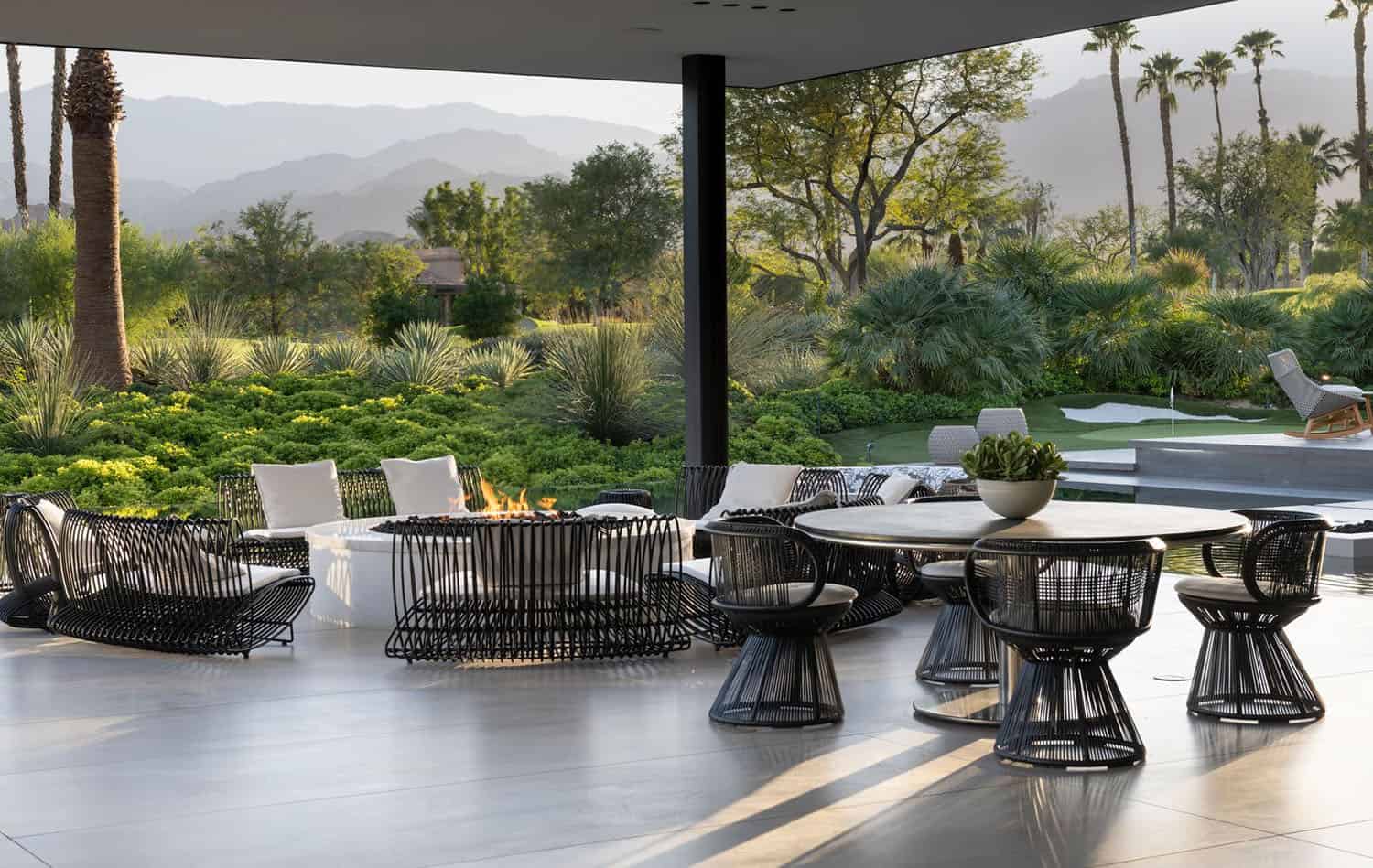 modern luxury house exterior with a covered patio and outdoor furniture