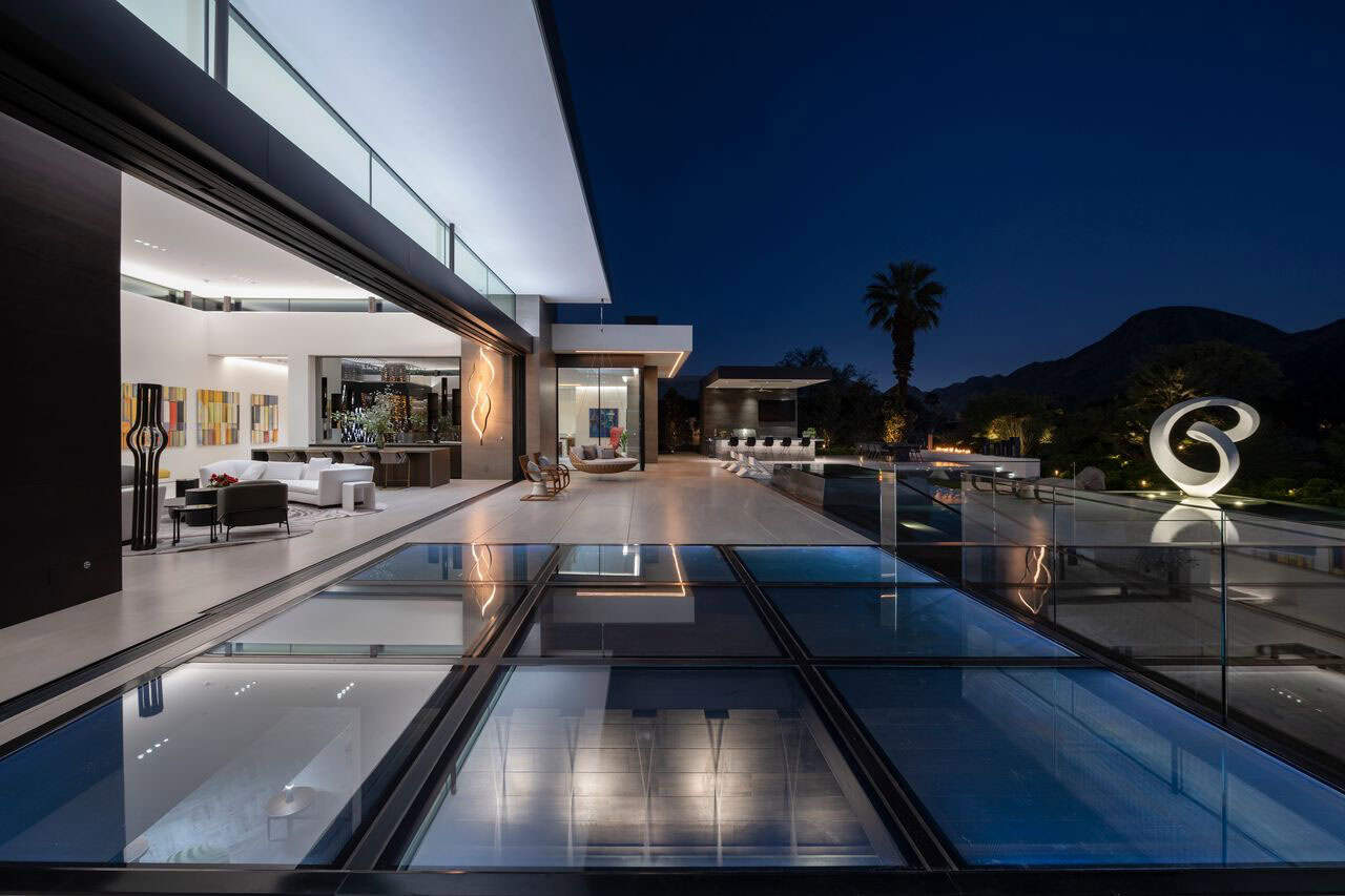 modern luxury house exterior with a pool at dusk