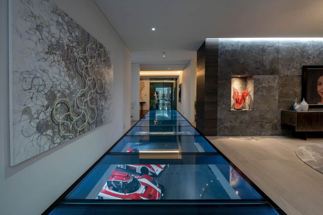 modern hallway with glass and a view of the car museum below