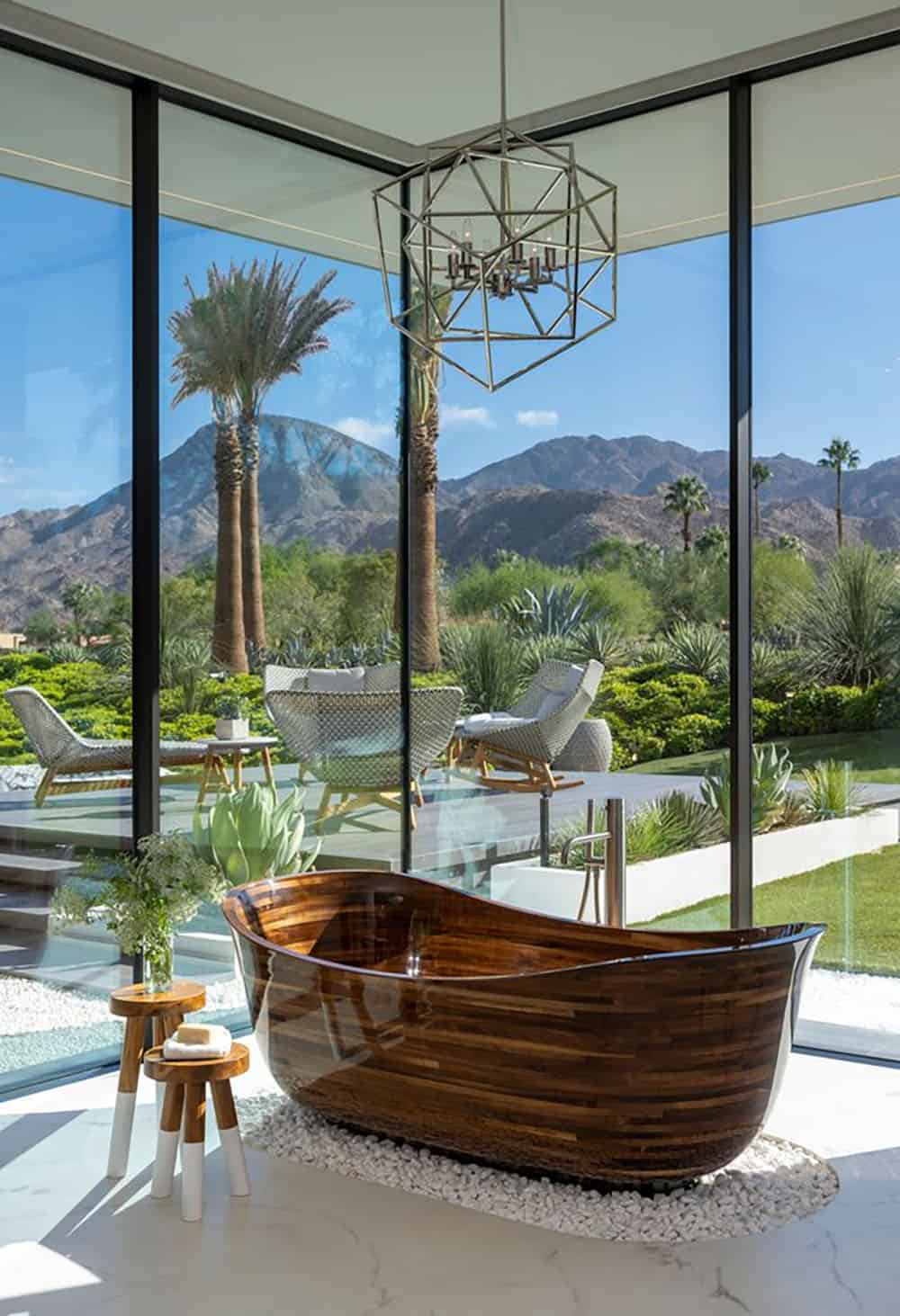 A bathroom with a large tub and a view of the mountains.