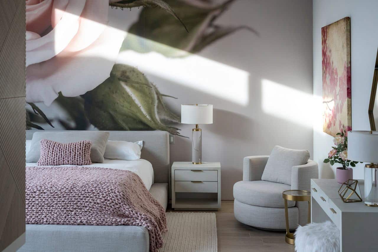 A bedroom with a large floral wall mural.
