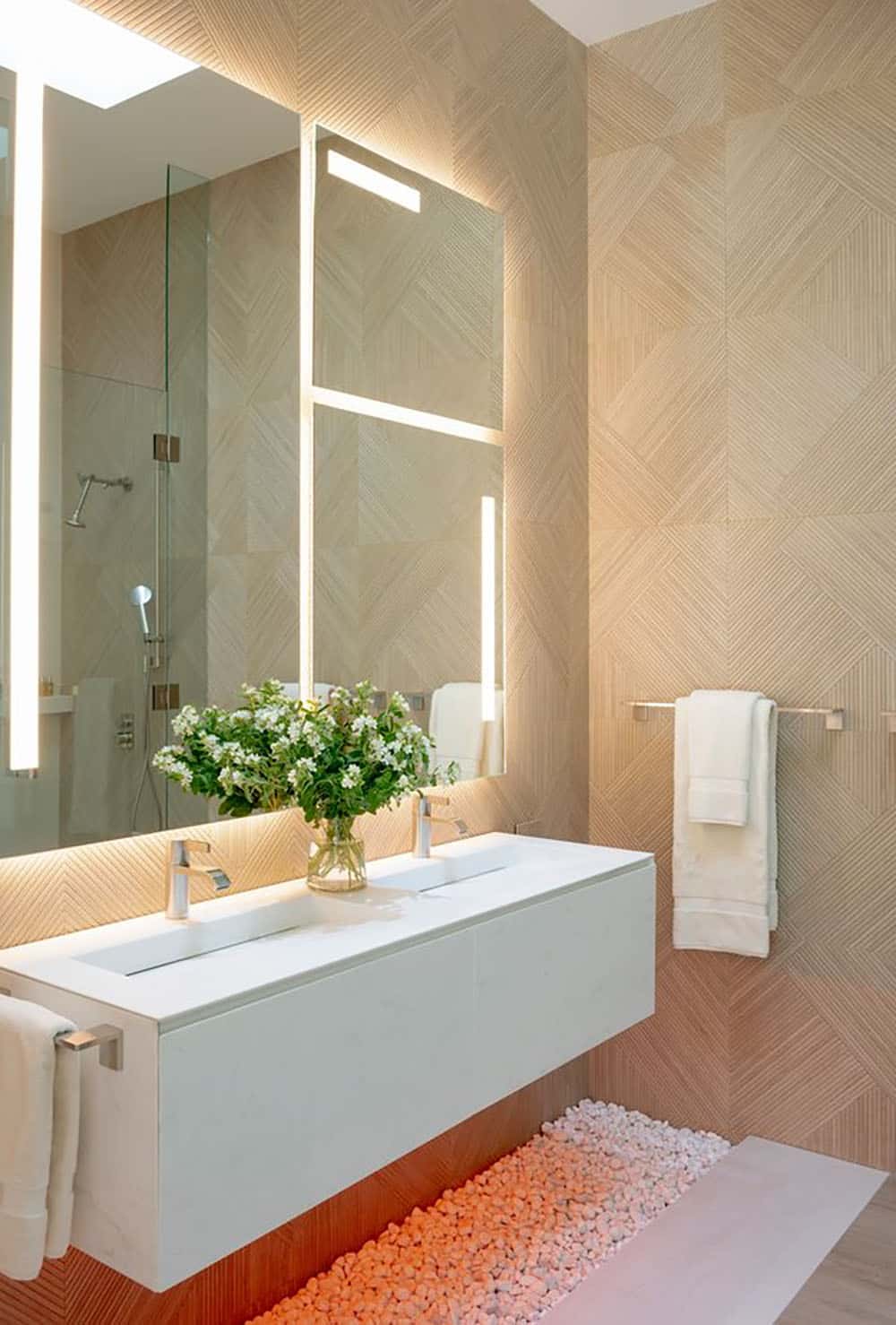 A bathroom with a pink flower painted on the wall.