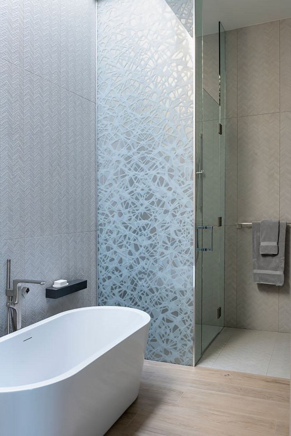 A modern bathroom with a glass shower door.