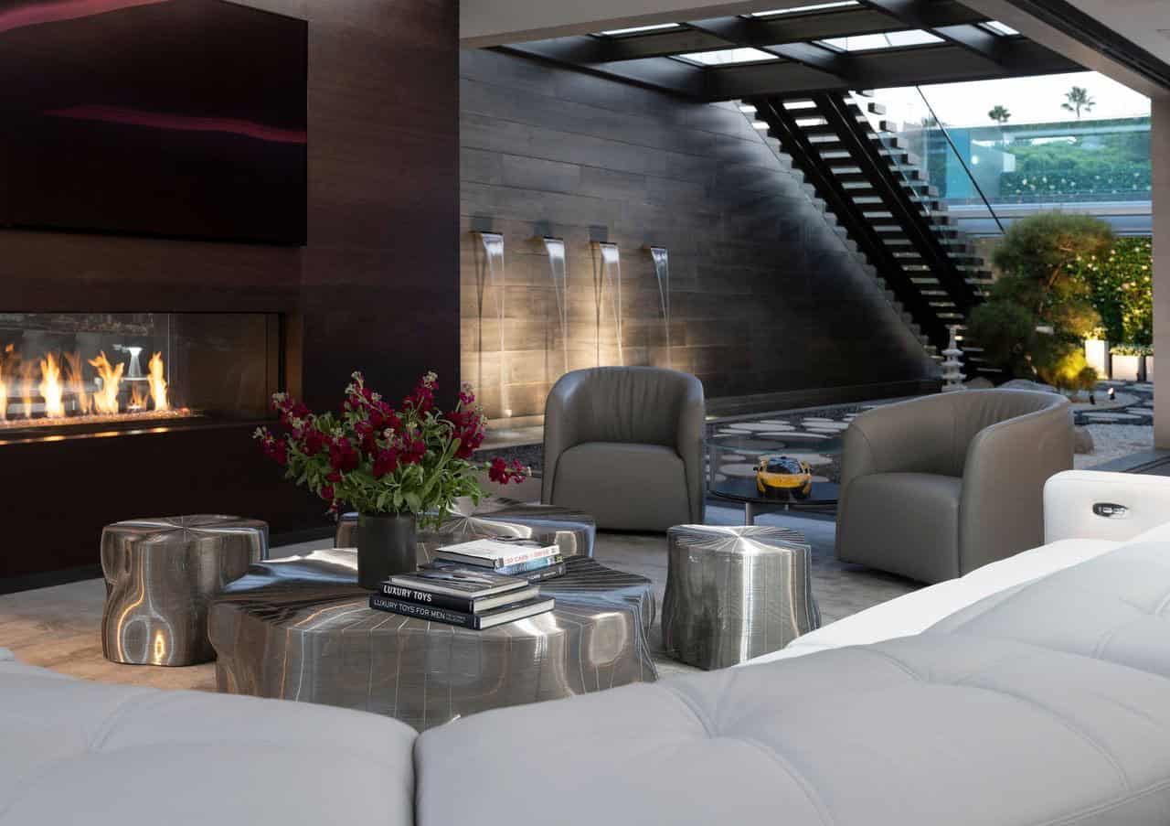 A modern family room with a fireplace and a staircase.