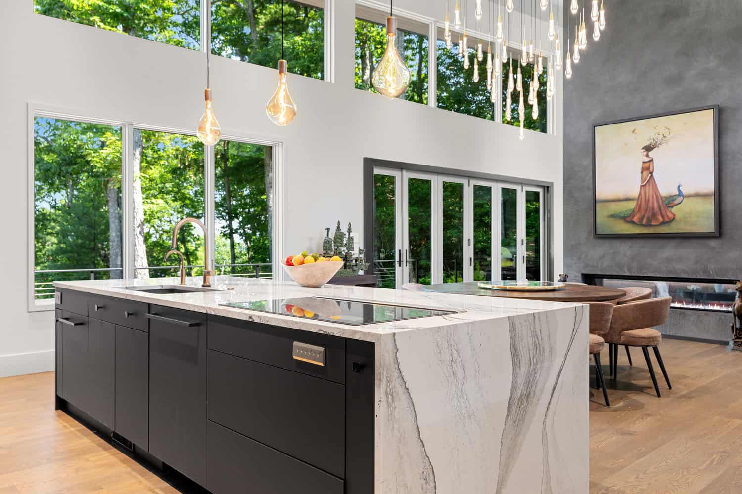 modern kitchen with a waterfall island and large window wall