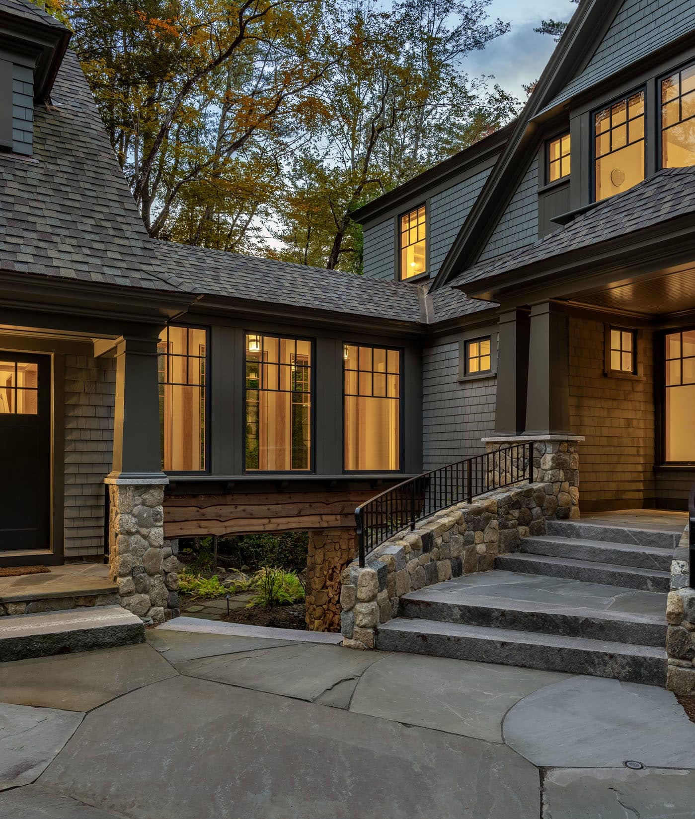 new england style lake house exterior at dusk