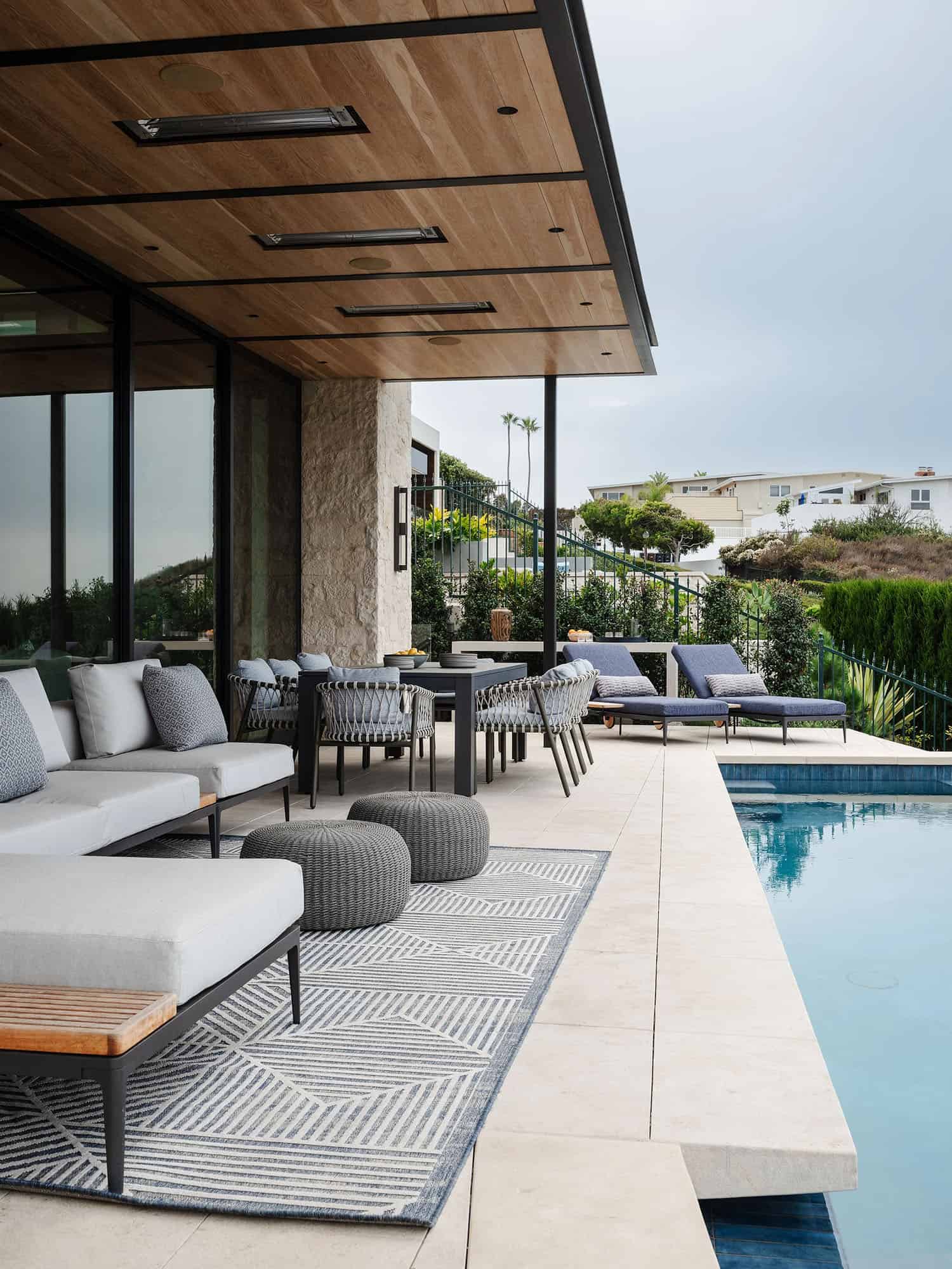 organic modern home exterior with a covered patio and a pool