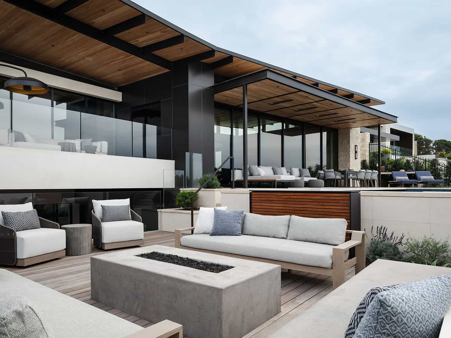 organic modern home exterior with a patio and a fire pit