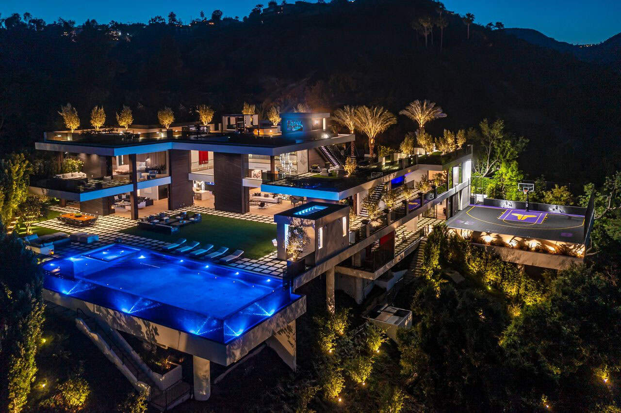 modern house exterior with a pool at dusk