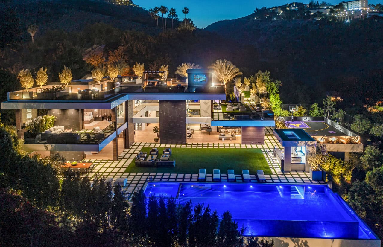 modern house exterior with a pool at dusk