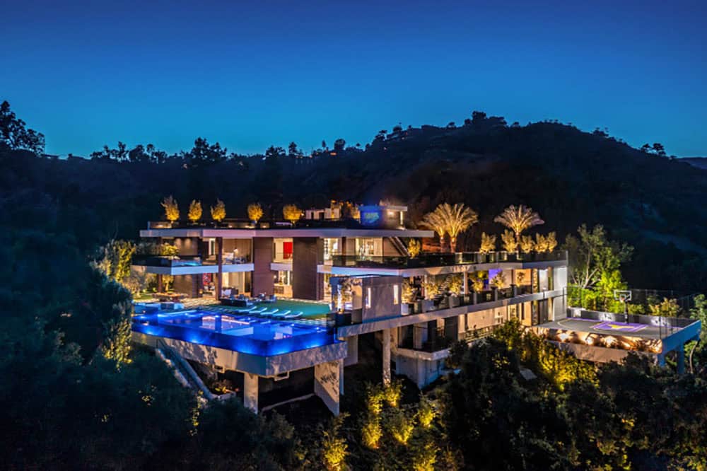 modern house exterior with a pool at dusk