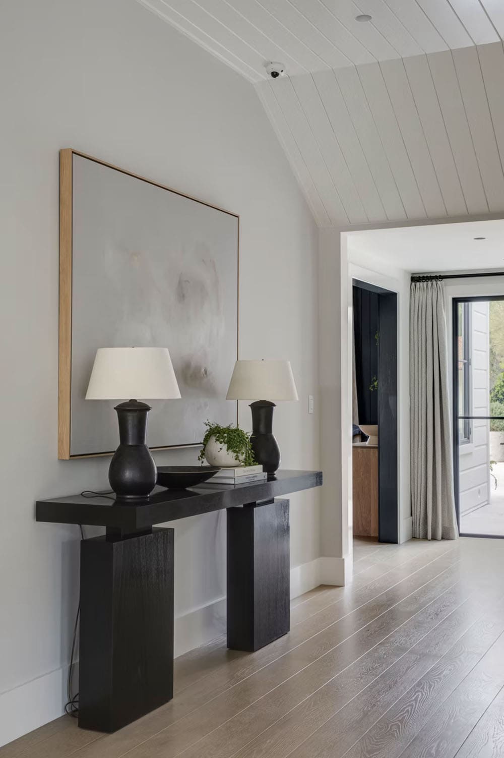 transitional style home entry with a console table