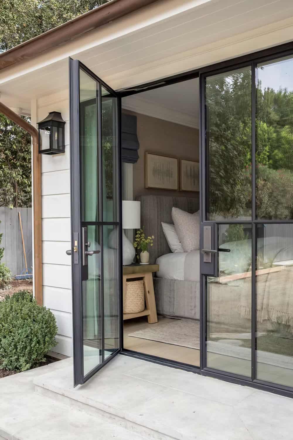 transitional style bedroom with glass and steel french doors