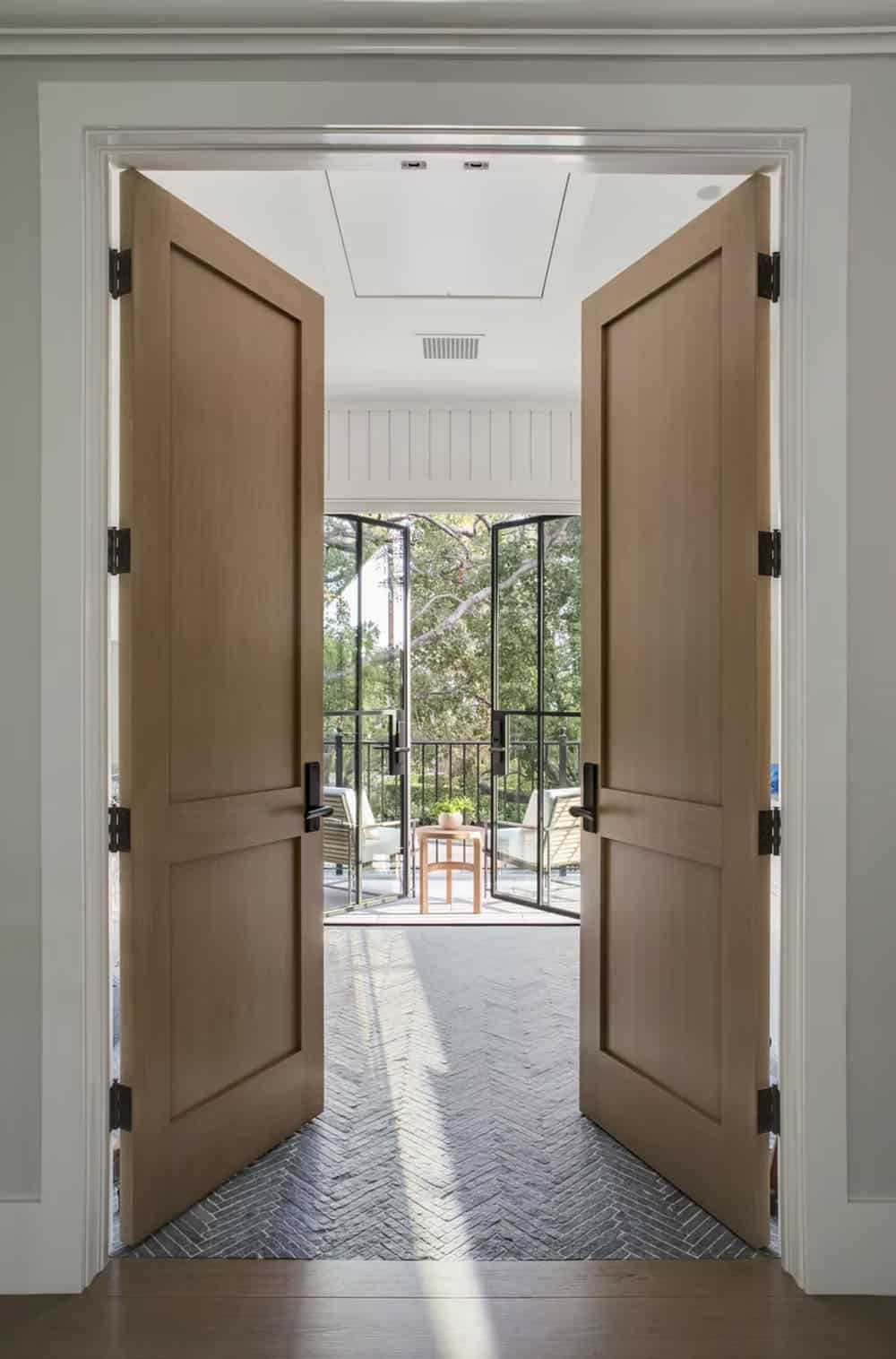 transitional style bedroom with wood doors