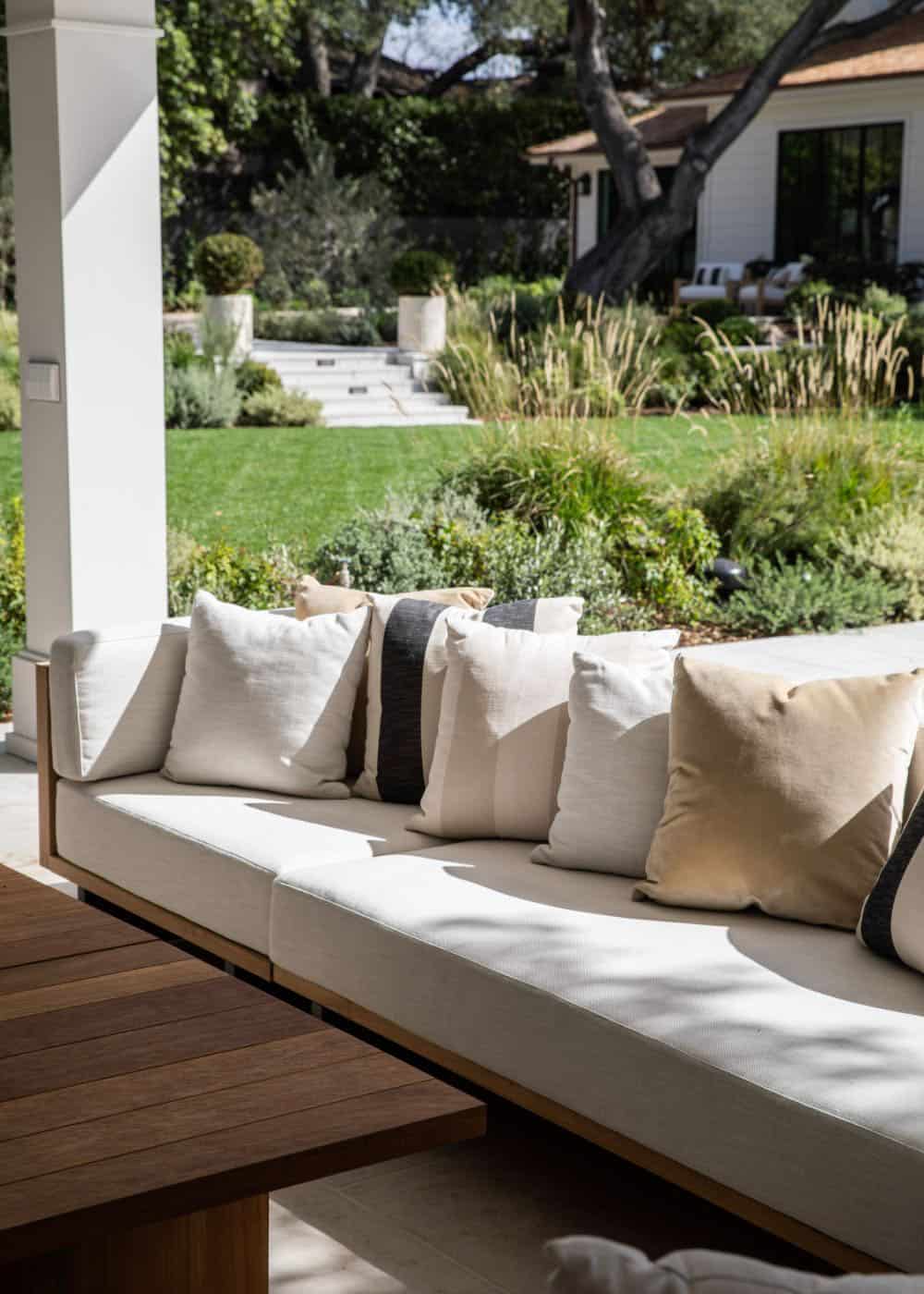 southern inspired home exterior with a covered patio and buit-in outdoor seating