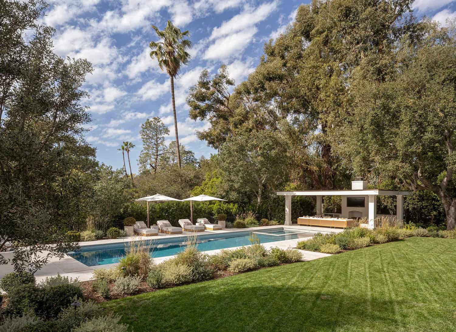 southern inspired home exterior landscape with a pool