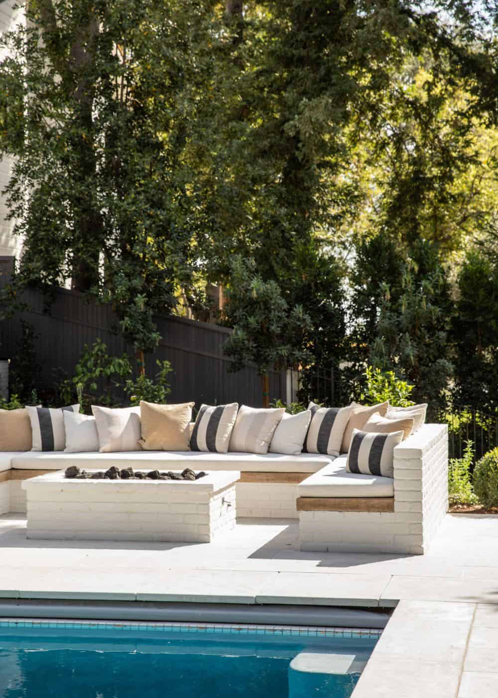 southern inspired home exterior patio with outdoor furniture and a fire pit