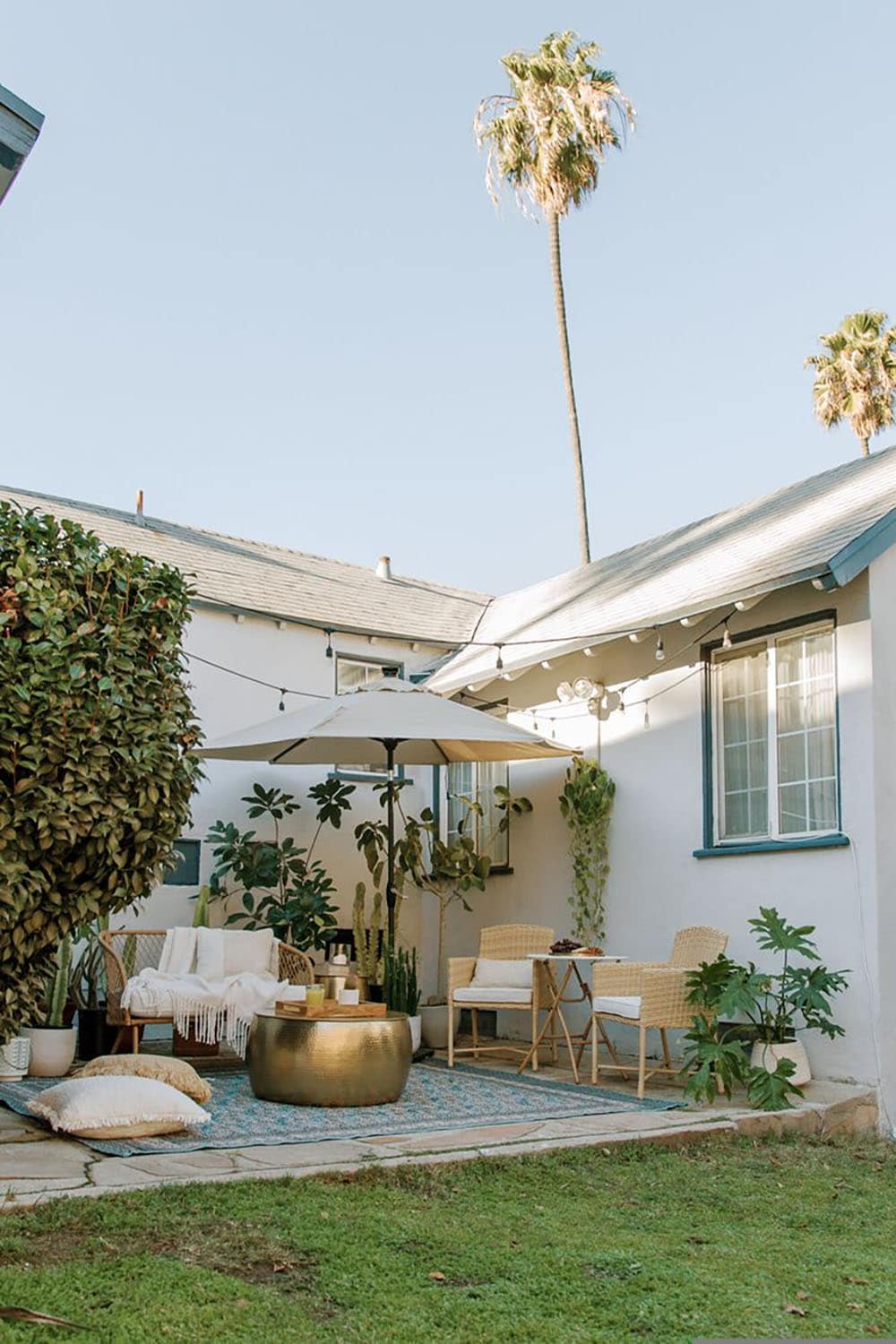 small backyard patio with outdoor furniture and string lights