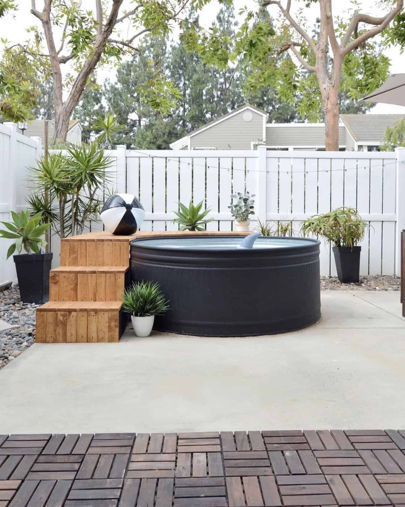small backyard patio with a stock tank pool