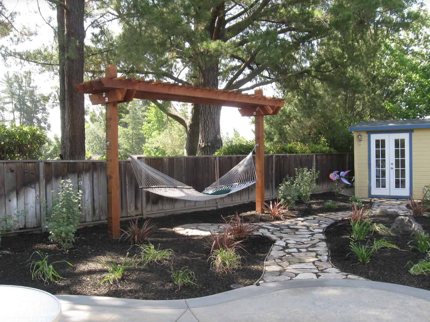 pergola with a hammock in a backyard patio