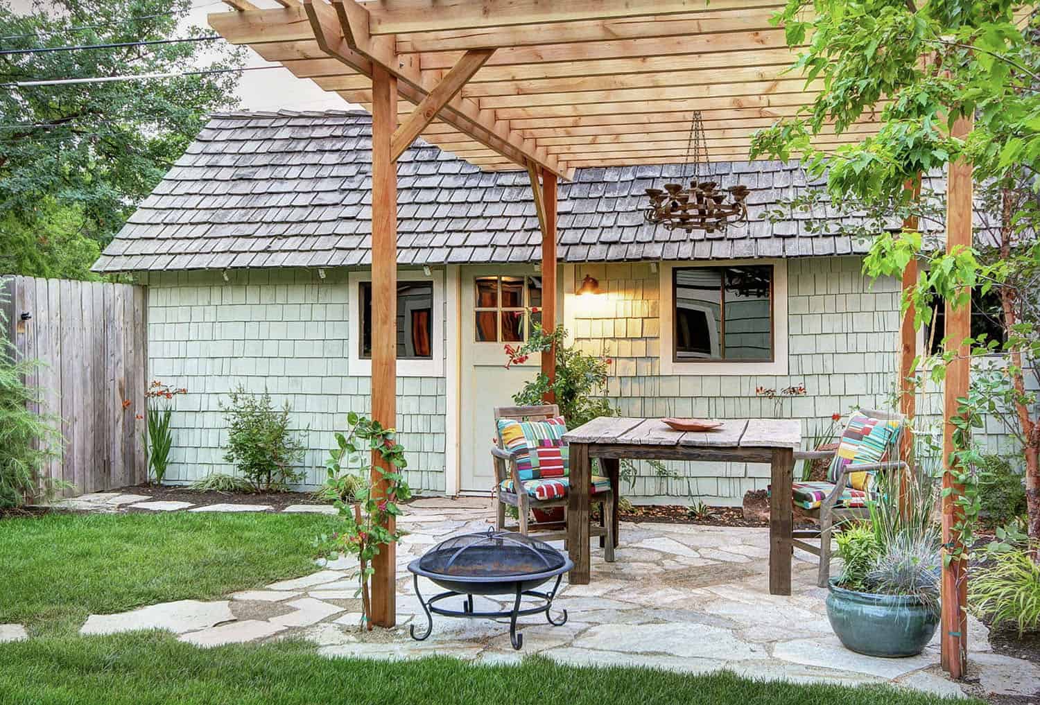 small backyard patio with a pergola and dining table