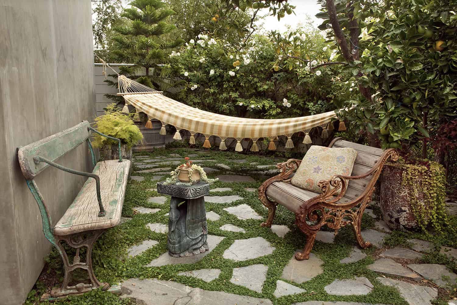 bohemian eclectic backyard patio with a bench and hammock