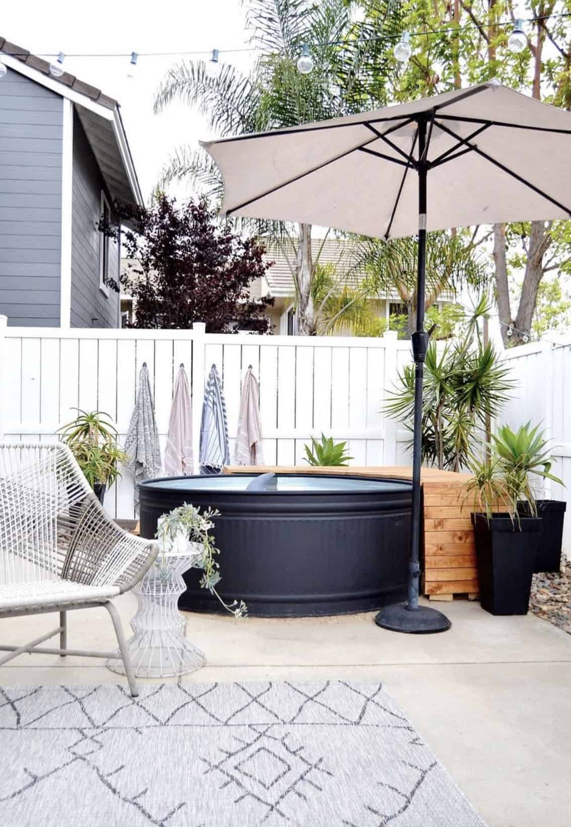 small backyard patio with a stock tank pool