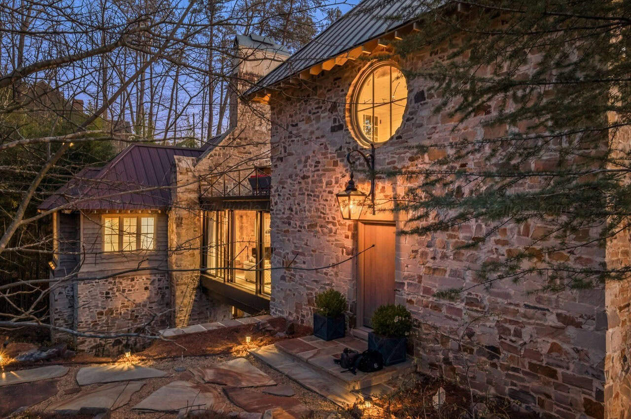 stone lake house exterior at dusk